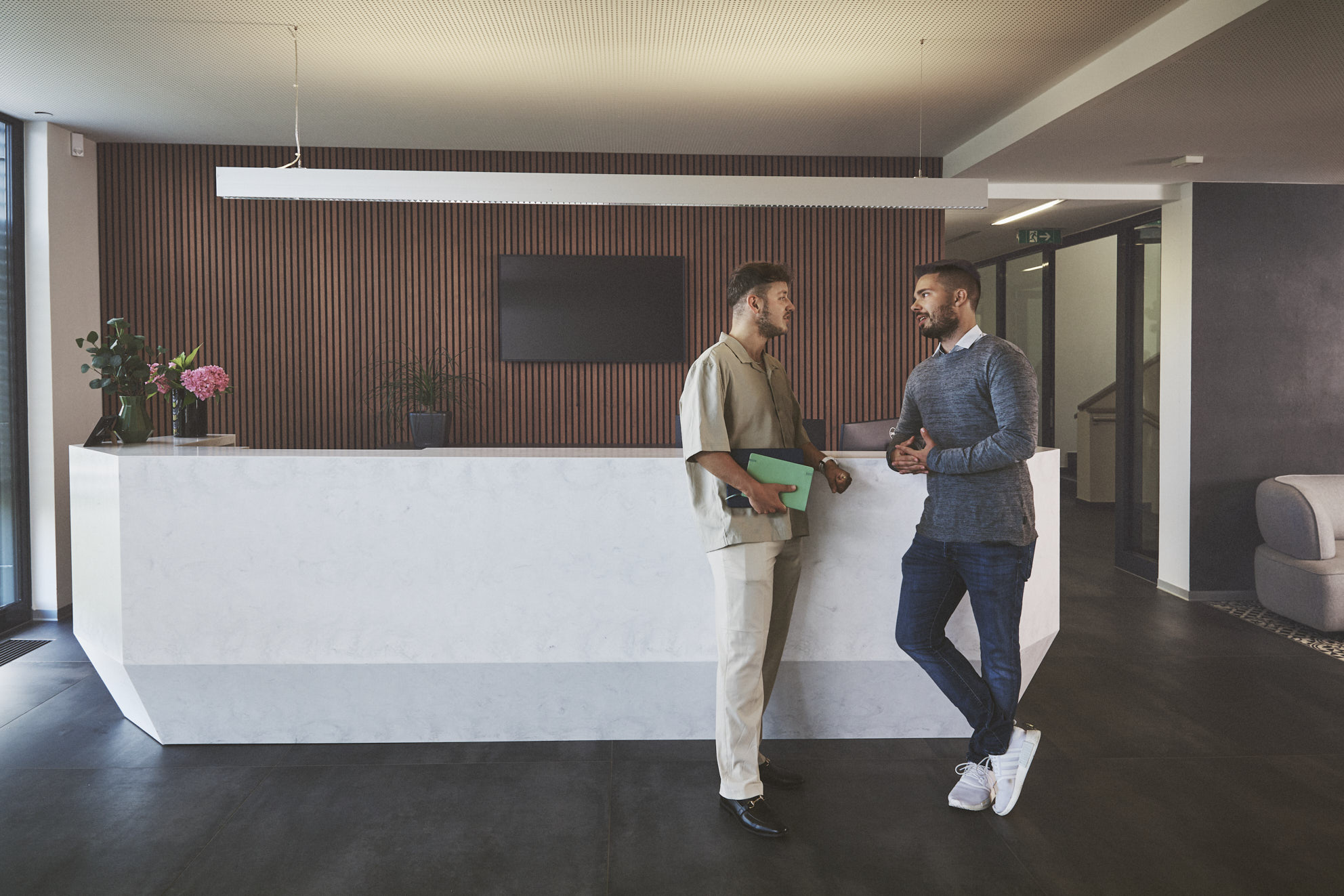 Zwei Frauen sitzen im Meetingraum und schauen freudig in den Arbeitslaptop. Hier erklärt die eine Frau der anderen die Vorteile der Lieferpartnerschaft und des HOGAST Netzwerkes.